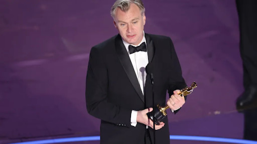 Christopher Nolan accepting an award at the academy awards 2024.